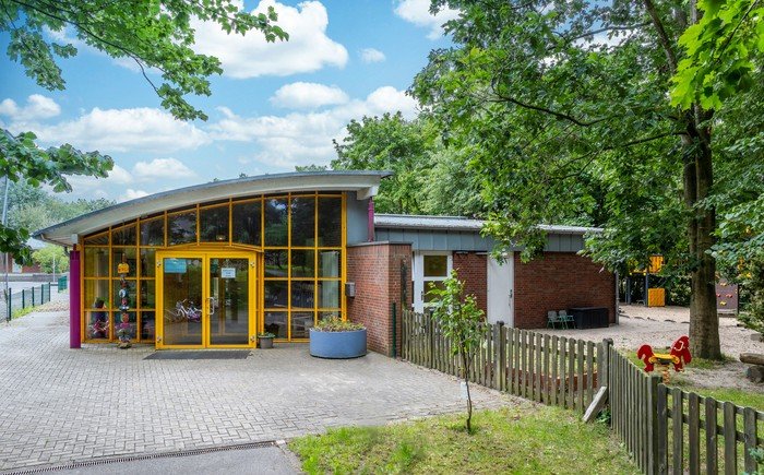 Helles Kirchenkindergarten-Gebäude mit spielerischem Design.